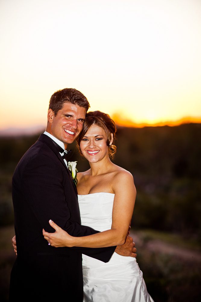 bride and groom smiling for a sunset shot