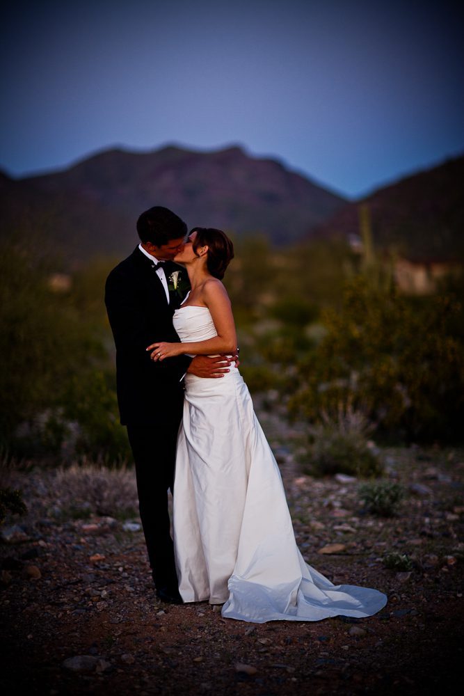 bride and groom kissing for a formal photograph