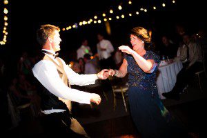 the groom and his mother having a great time dancing at the reception