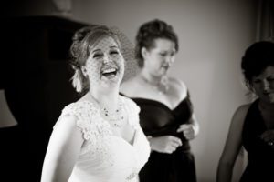 the bride laughing while getting ready