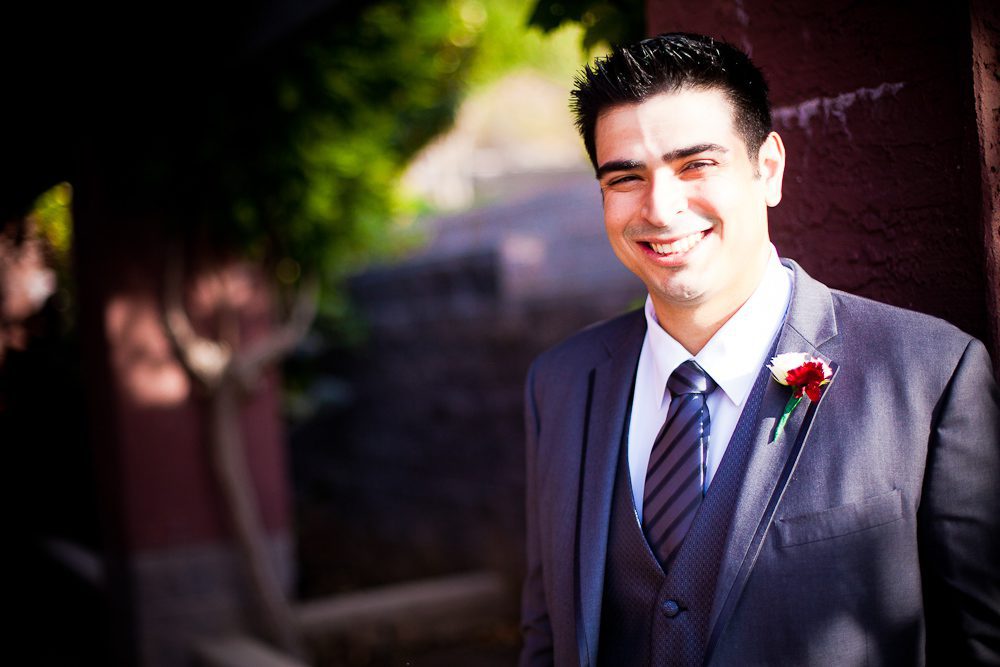 the groom smiling before first look