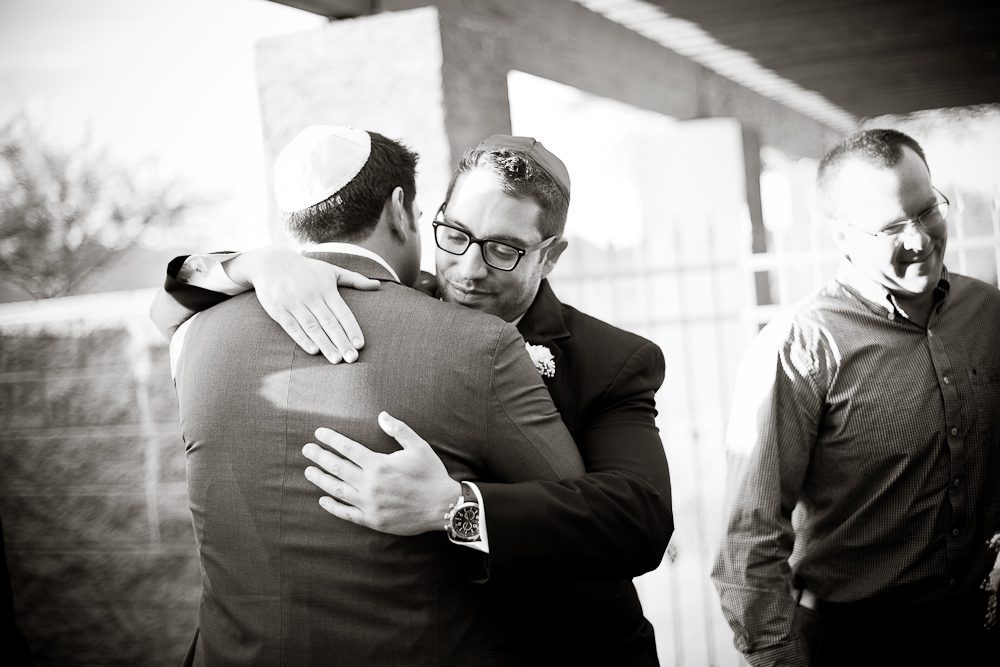 a groomsmen congratulating the groom after being married