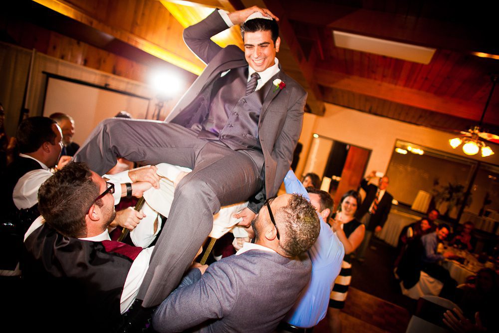 groom being carried in a chair