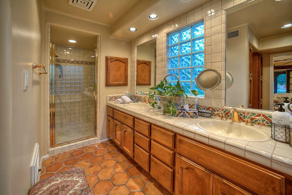 master bathroom with double sinks and separate shower